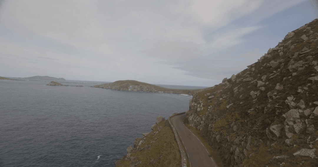 Transparent Coastal Mountain Road Along Cliffs and Tranquil Sea
