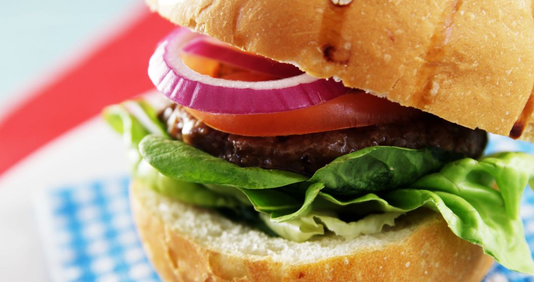 Close-Up of Fresh Gourmet Burger with Lettuce, Tomato, and Red Onion - Free Images, Stock Photos and Pictures on Pikwizard.com