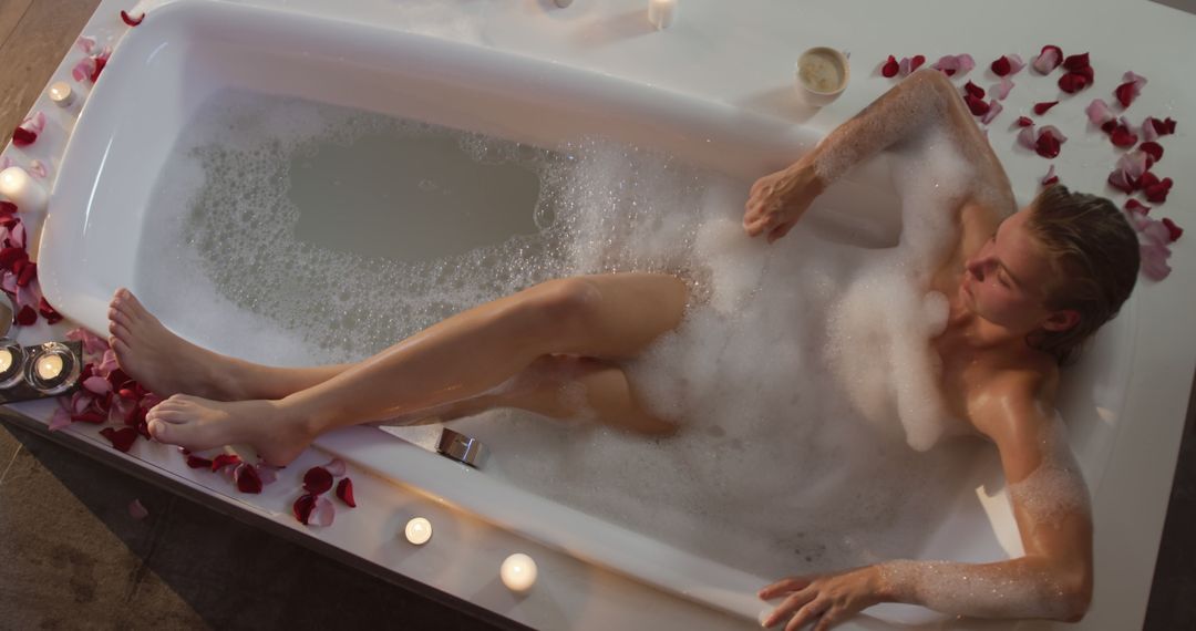 Woman Relaxing in Bubble Bath with Rose Petals and Candles - Free Images, Stock Photos and Pictures on Pikwizard.com