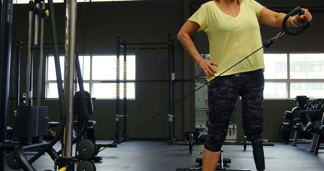 Middle-Aged Woman Exercising with Cable Machine in Gym - Free Images, Stock Photos and Pictures on Pikwizard.com