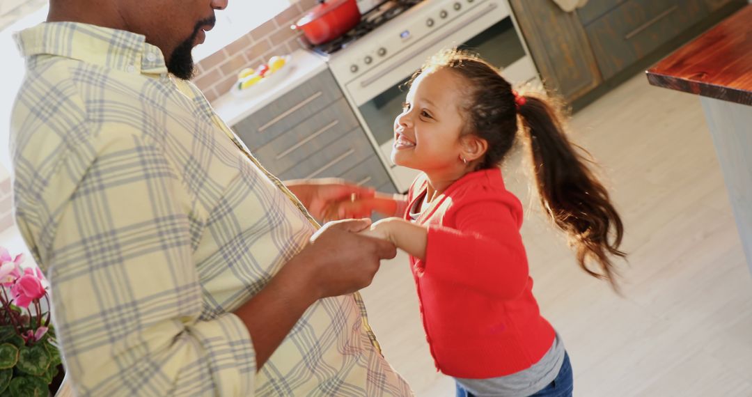 Father and Daughter Dancing Together in Bright Kitchen - Free Images, Stock Photos and Pictures on Pikwizard.com