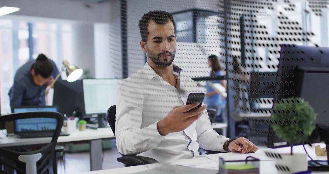 Businessman Analyzing Mobile Data in Modern Office