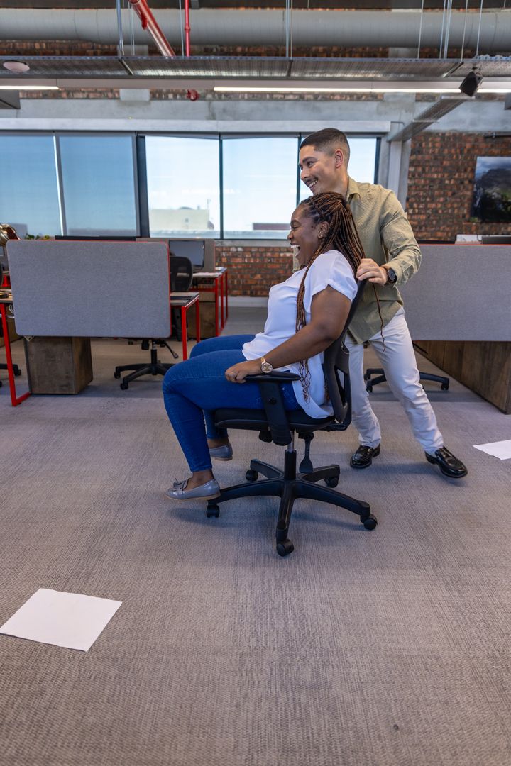 Diverse Coworkers Enjoying Fun Break in Open Office