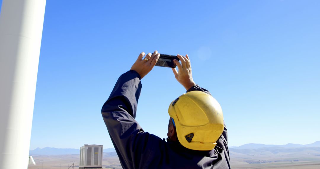 An engineer uses his smartphone to document or inspect work at an industrial site. - Free Images, Stock Photos and Pictures on Pikwizard.com