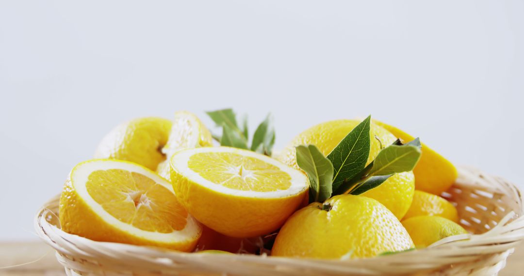 Fresh Lemons in Wicker Basket with Green Leaves - Free Images, Stock Photos and Pictures on Pikwizard.com