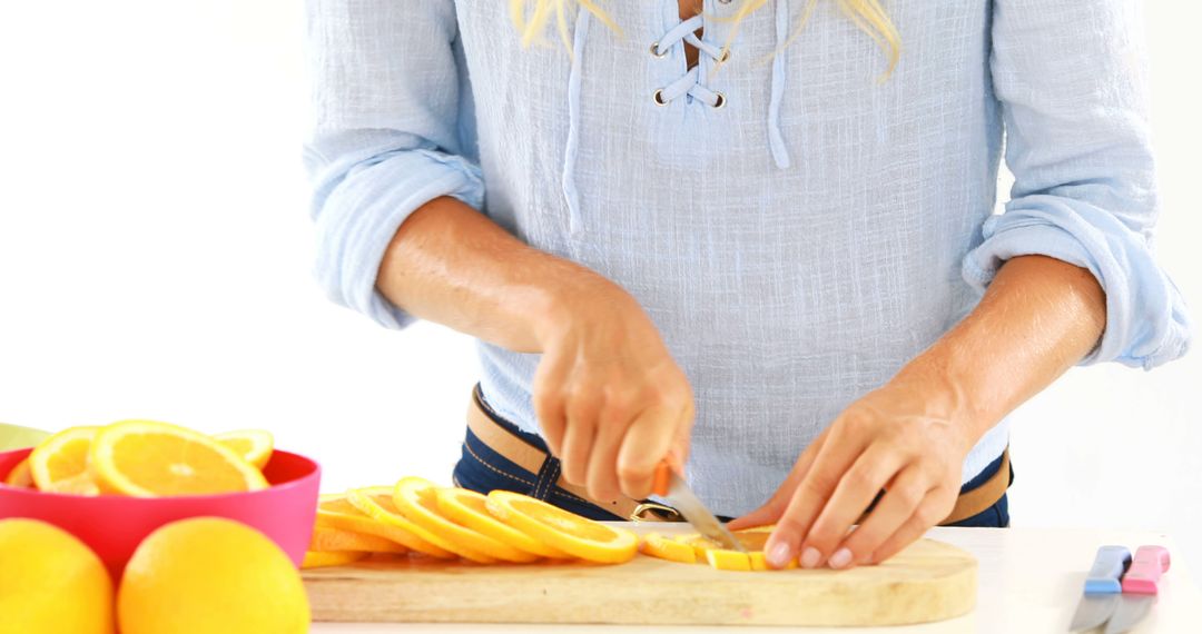 Woman Slicing Fresh Citrus Fruits in Kitchen - Free Images, Stock Photos and Pictures on Pikwizard.com