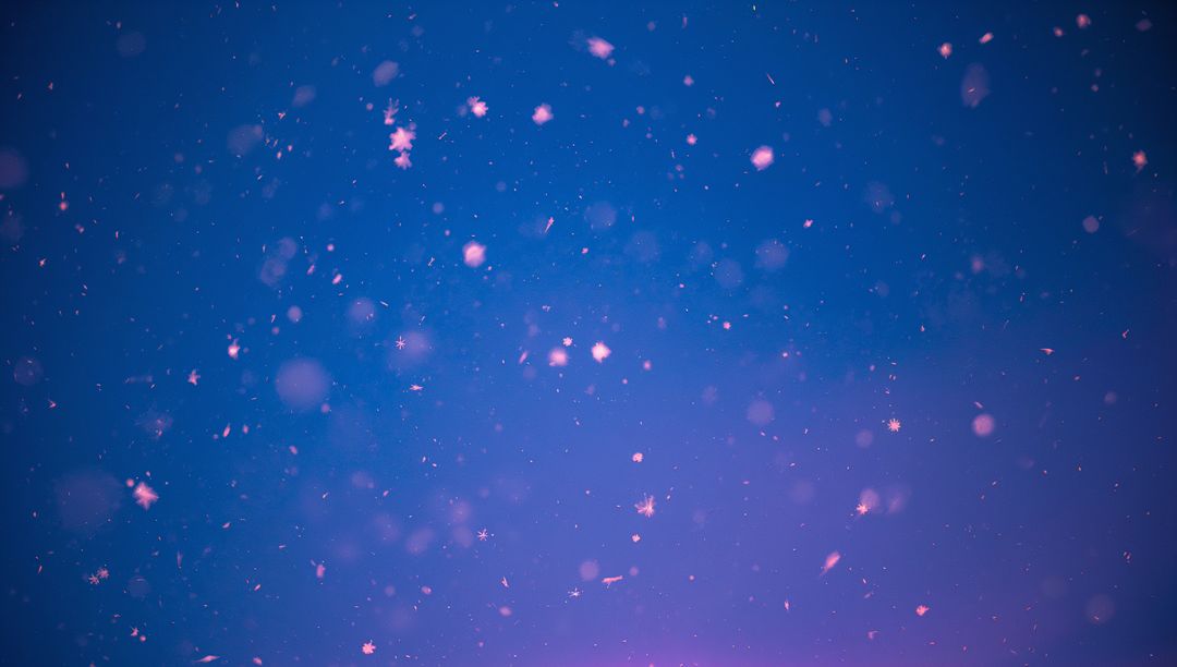 Floating Snowflakes Against Ethereal Violet Winter Sky