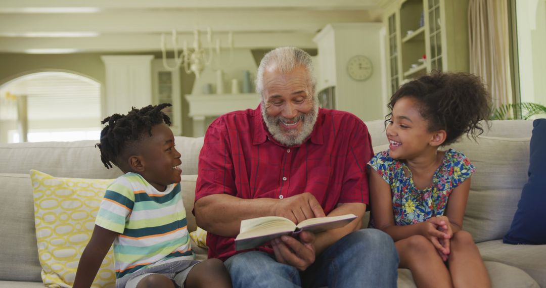 Grandfather Reading to Happy Grandchildren on Sofa at Home - Free Images, Stock Photos and Pictures on Pikwizard.com