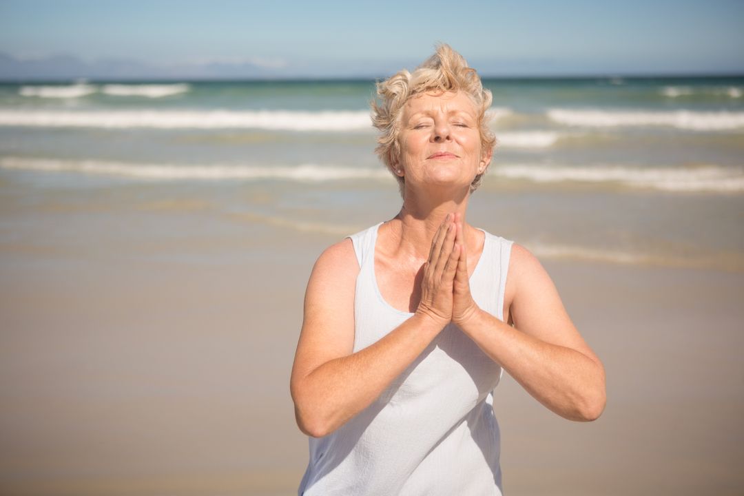 Elderly Woman Practicing Mindfulness on Beach - Free Images, Stock Photos and Pictures on Pikwizard.com