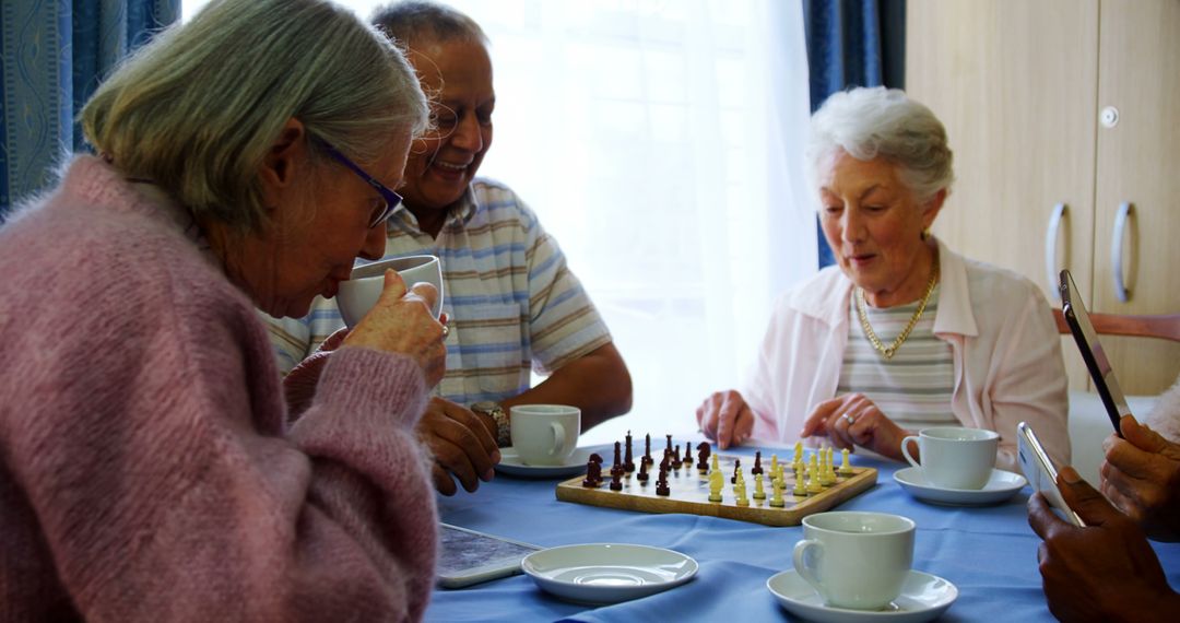 Seniors Enjoying Coffee While Playing Chess at Retirement Home - Free Images, Stock Photos and Pictures on Pikwizard.com