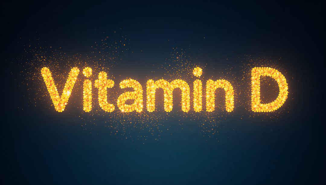 Glowing Vitamin D lettering formed from golden particles with sparkles on deep blue
