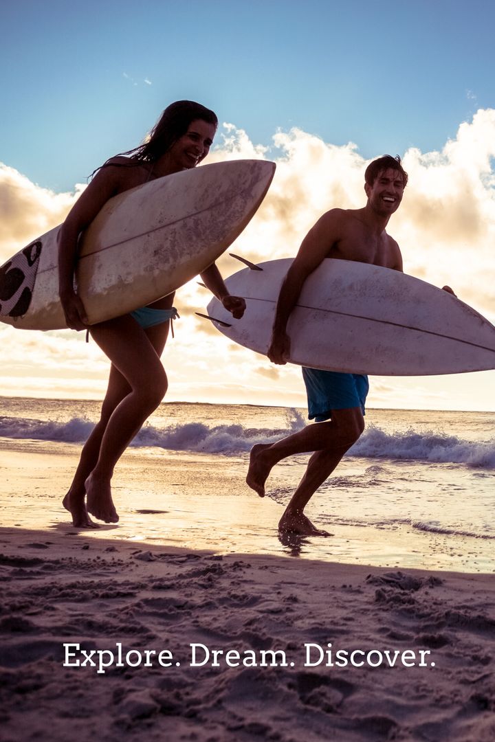 Joyful Surfers Running with Surfboards at Sunset on Beach - Download Free Stock Templates Pikwizard.com