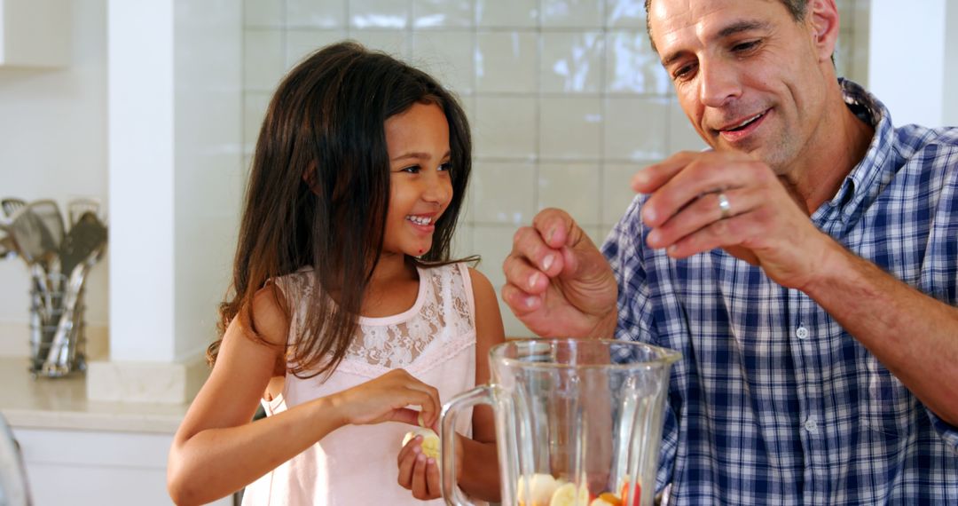 Father and Daughter Making Fruit Smoothie, Enjoying Quality Time in Kitchen - Free Images, Stock Photos and Pictures on Pikwizard.com