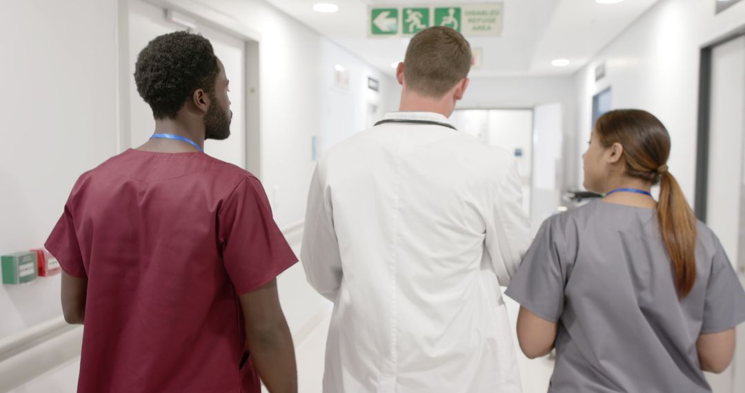 Doctors and Nurses Walking in Hospital Hallway - Free Images, Stock Photos and Pictures on Pikwizard.com