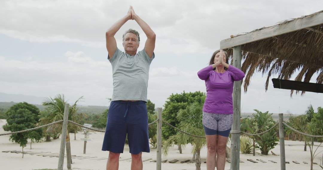 Senior Couple Practicing Yoga on Sandy Beach for Relaxation - Free Images, Stock Photos and Pictures on Pikwizard.com