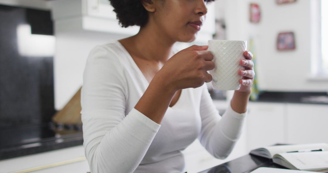 Woman Enjoying Coffee in Modern Kitchen - Free Images, Stock Photos and Pictures on Pikwizard.com