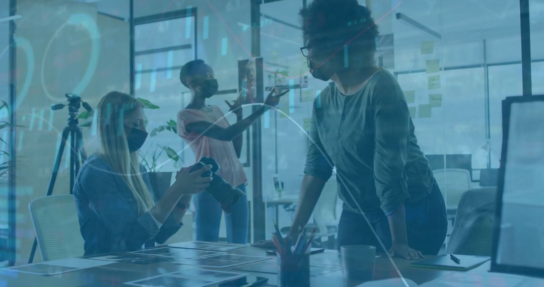 Diverse Team Working on Office Project with Financial Data Overlay