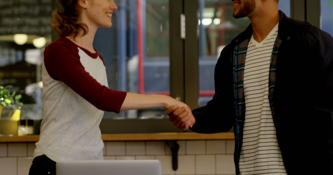 Two People Greeting with Handshake in Office Environment - Free Images, Stock Photos and Pictures on Pikwizard.com
