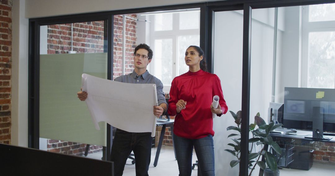 Architects Reviewing Blueprints in Industrial Style Office - Free Images, Stock Photos and Pictures on Pikwizard.com