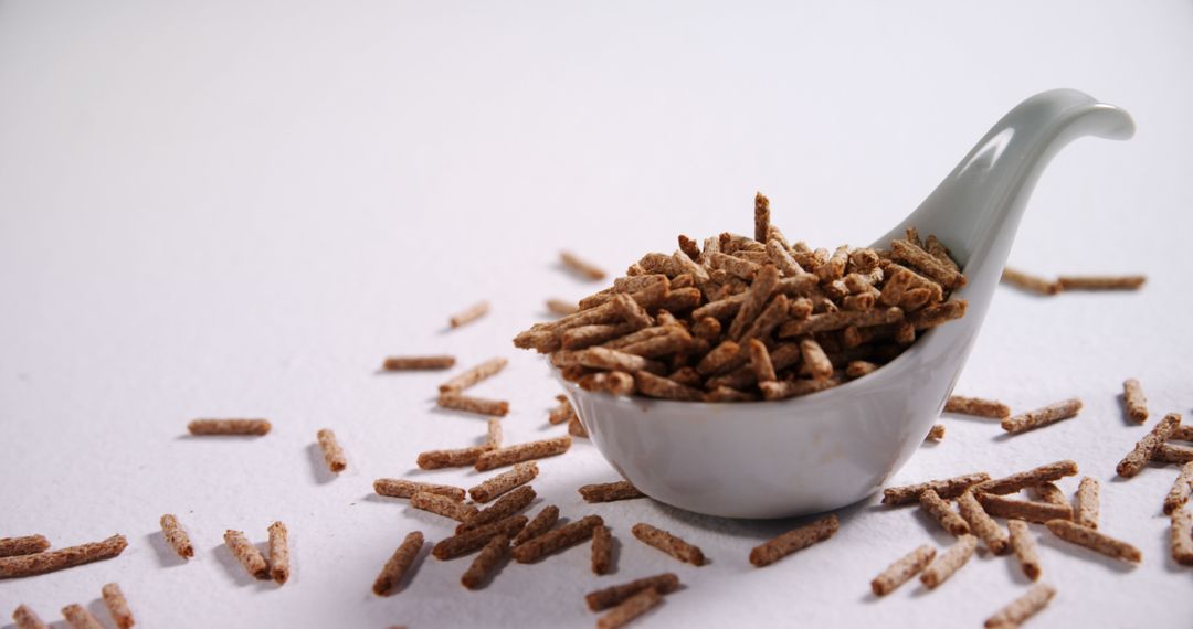 Healthy High-Fiber Bran Sticks in Ceramic Spoon on White Background - Free Images, Stock Photos and Pictures on Pikwizard.com