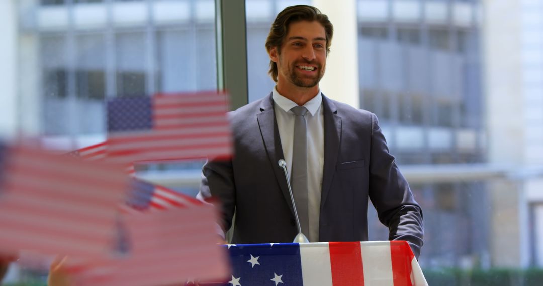 Confident Businessman Speaking at Event with American Flags
