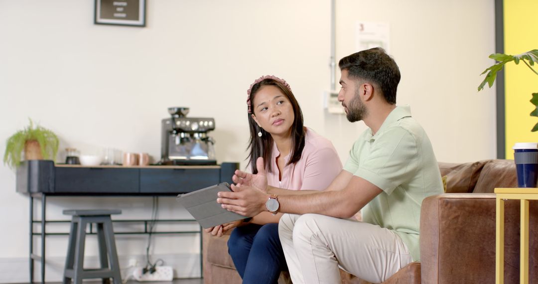 Business Colleagues Using Tablet and Having a Discussion in Modern Office