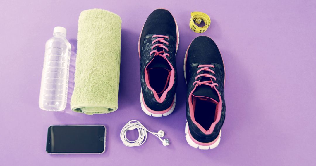 Fitness Essentials on Purple Background with Sneakers Water Bottle and Towel - Free Images, Stock Photos and Pictures on Pikwizard.com