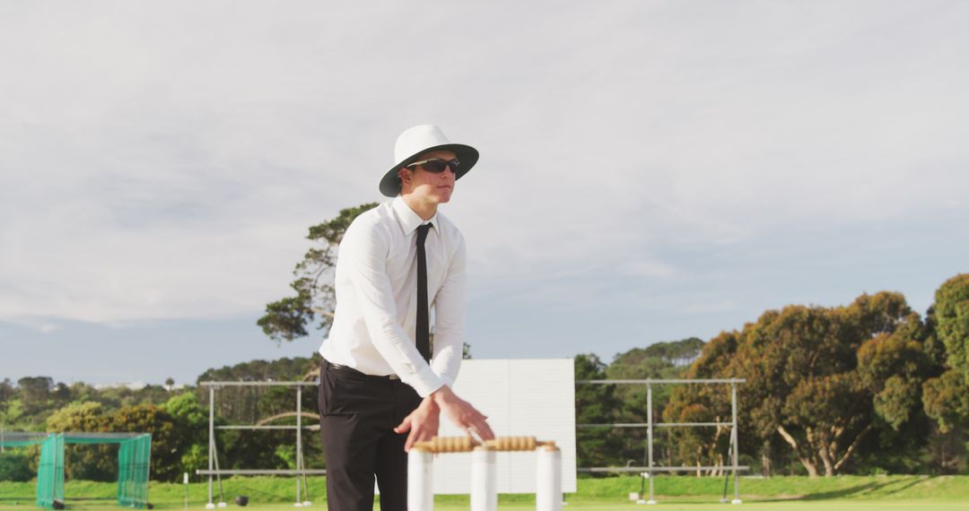 Cricket Umpire Preparing for Match Outdoors Wearing White Attire - Free Images, Stock Photos and Pictures on Pikwizard.com