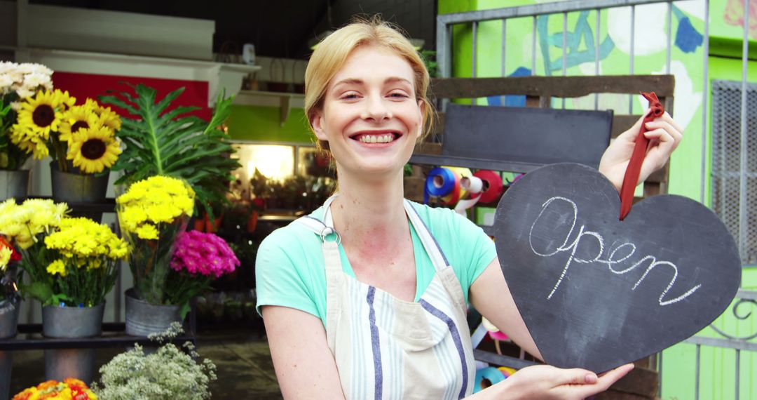 Smiling Florist Holding 'Open' Sign at Flower Shop Entrance - Free Images, Stock Photos and Pictures on Pikwizard.com