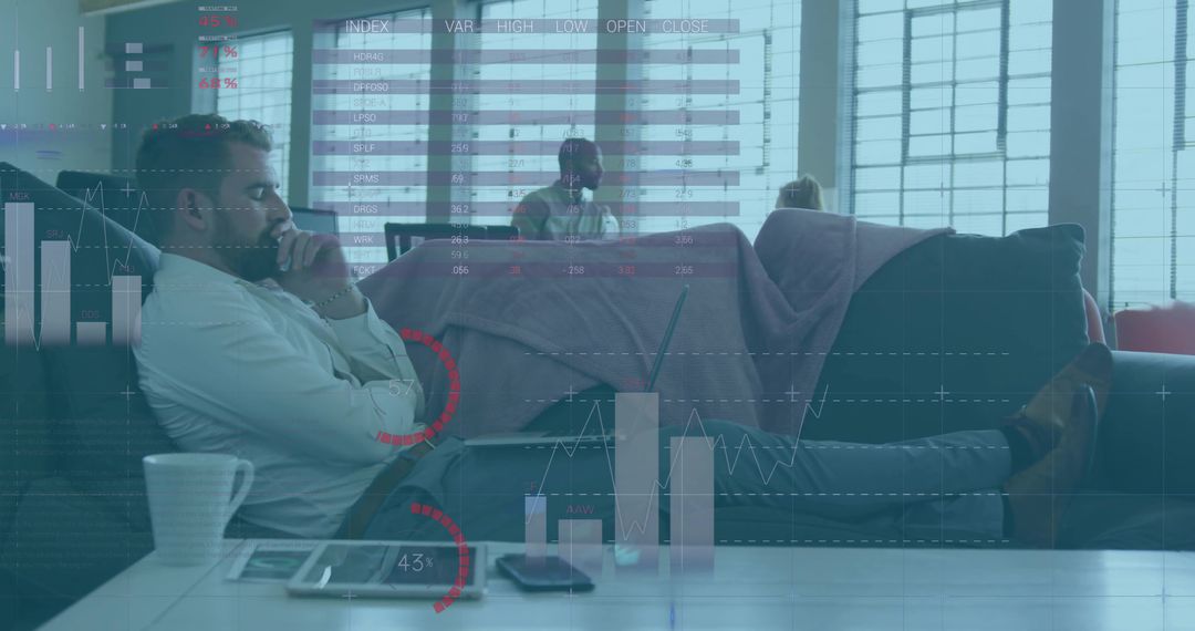 Bearded man pondering data analytics reclining on sofa with tablet and charts overlay