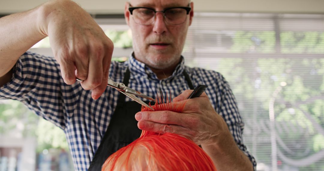 Senior Hairdresser Cutting Bright Orange Hair in Salon - Free Images, Stock Photos and Pictures on Pikwizard.com