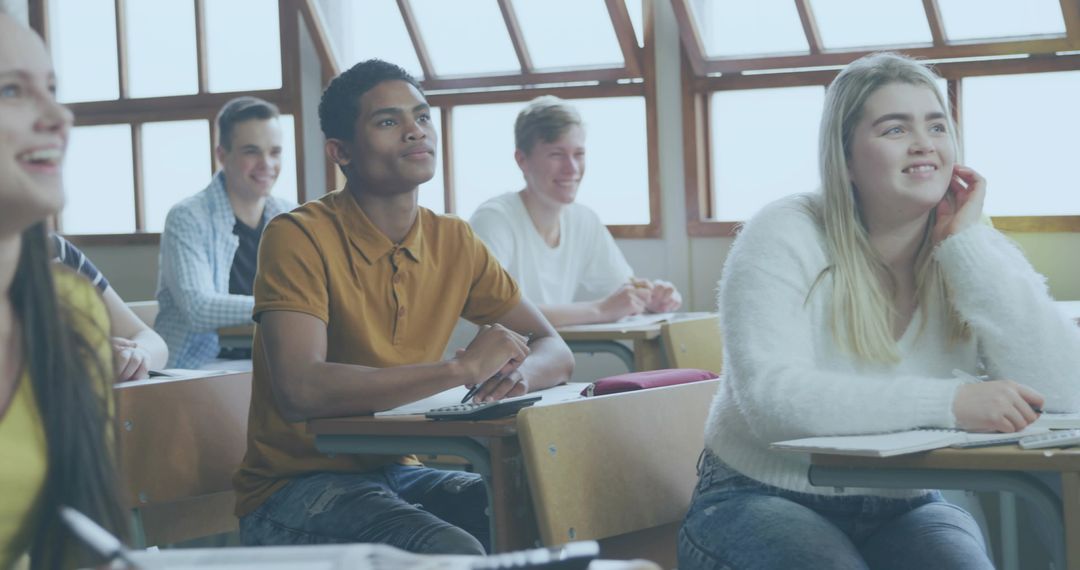 High School Students Studying and Writing in Sunlit Classroom with Desks Taking Notes