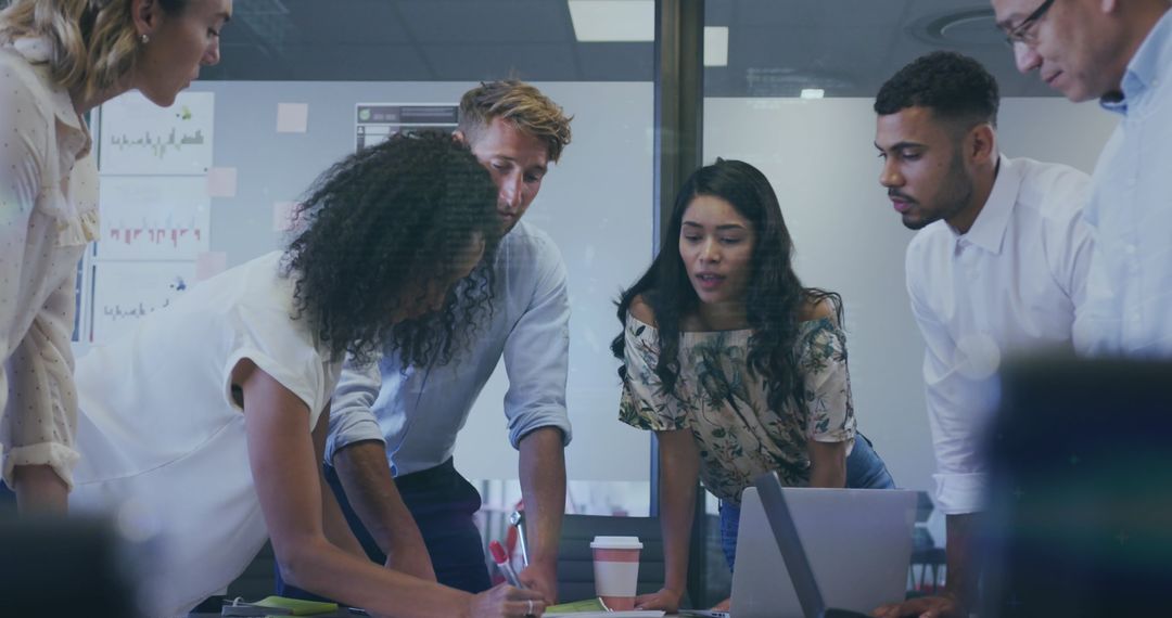 Diverse Team Collaborating in Office Setting with Technology