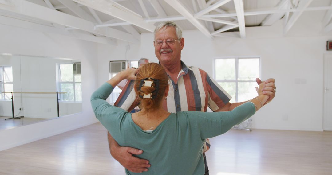 Elderly Couple Embracing In Dance Class - Free Images, Stock Photos and Pictures on Pikwizard.com