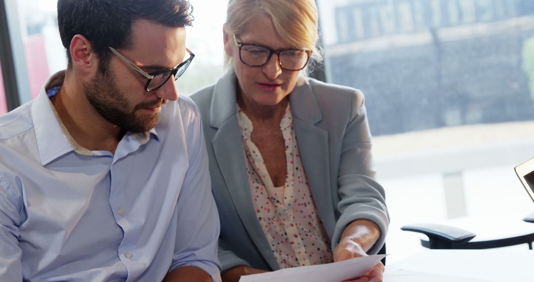 Business Colleagues Reviewing Document in Office Setting