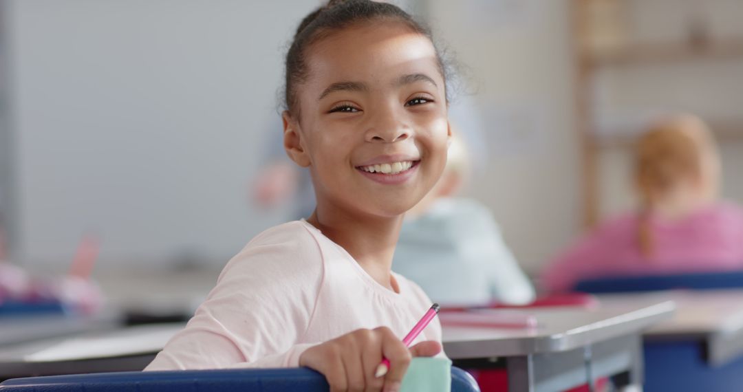 Happy Student Smiling at Desk in Classroom Setting