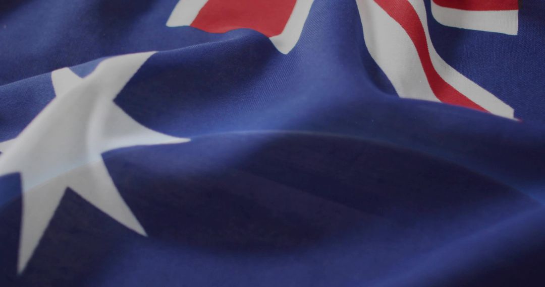 Macro close-up of Australian flag fabric folding showing white star and partial Union Jack