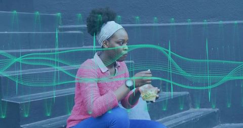Woman eating salad on urban steps with digital waveform graphic overlay