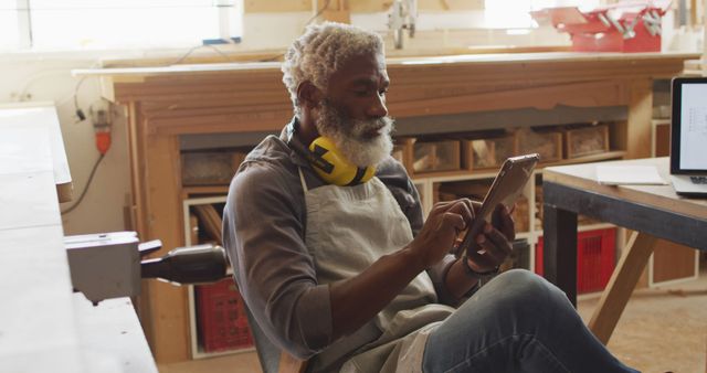 Elderly Woodworker Using Digital Tablet in Workshop - Download Free Stock Images Pikwizard.com