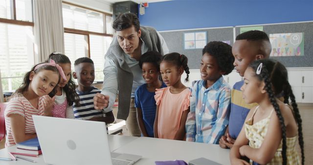 Teacher Engaging Diverse Group of Children in Classroom Using Laptop - Download Free Stock Images Pikwizard.com