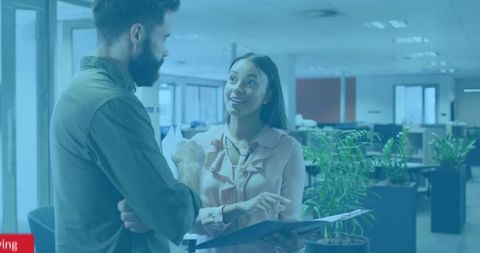 Two Professionals Collaborating in Modern Open-Plan Office Space