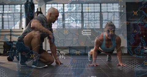 Female athlete holding plank while coach kneeling using performance analytics overlay