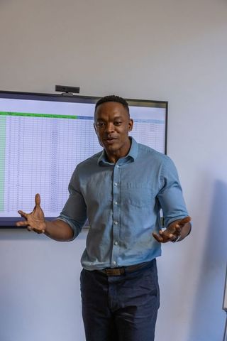 Professional Businessman Presenting Data in Meeting Room