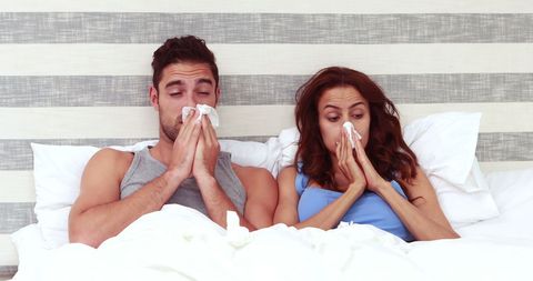 Sick Couple in Bed Blowing Nose with Tissues - Download Free Stock Images Pikwizard.com