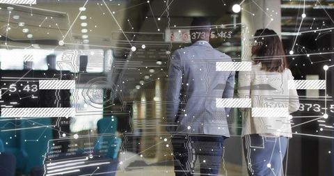 Business professionals walking through modern airport terminal with digital data overlay