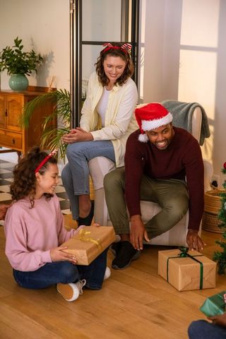 Family Sharing Gifts in Festive Living Room Setting