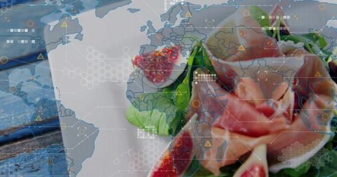 Blending figs, rose and prosciutto with digital world map overlay on rustic blue wood