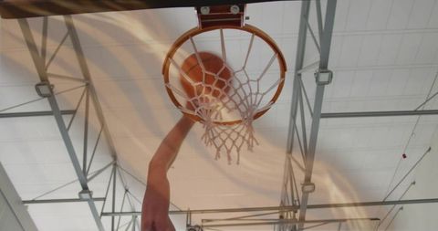 Dynamic Low Angle Shot of Basketball Dunk in Indoor Court