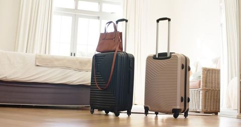 Stylish Luggage in Sunlit Bedroom Ready for Travel