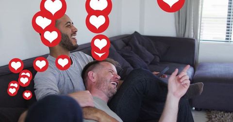 Two Men Enjoying Quality Time with Heart Notifications, Cozy Living Room